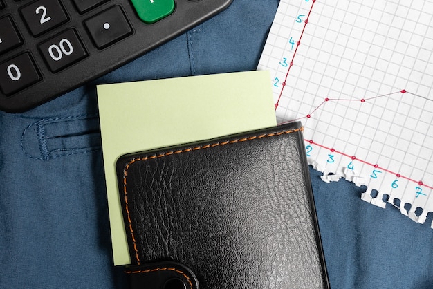 A close-up of receipts and invoices organized in a folder, with a calculator and a pen nearby, indicating diligent expense tracking.