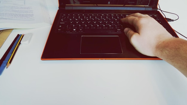 A close-up of a person's hands typing on a laptop, with a focus on the screen displaying code and a training program interface. The image conveys a sense of learning and skill development.