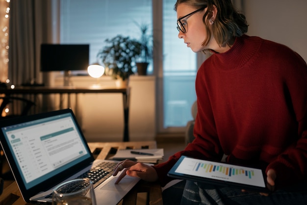 An individual reviewing a monthly budget spreadsheet on a laptop, highlighting potential savings in different spending categories.