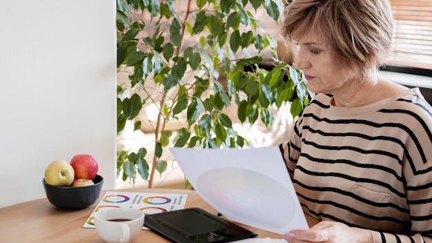 A freelancer reviewing a budget spreadsheet at a home desk, with tax documents and a calculator nearby, illustrating the focus on financial management and tax planning.