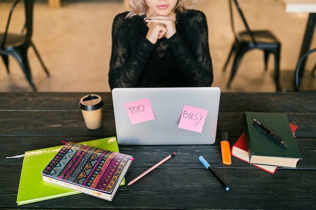 A freelancer participating in a virtual networking event on a laptop, surrounded by sticky notes of ideas and goals, symbolizing continuous learning and professional development.