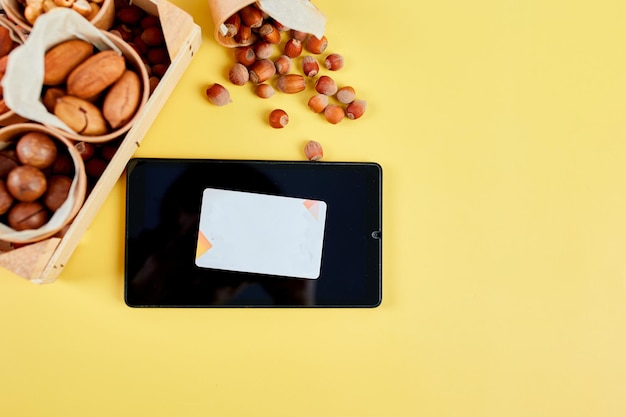 A close-up of a credit card showing a cash back symbol, with a background of various grocery items.