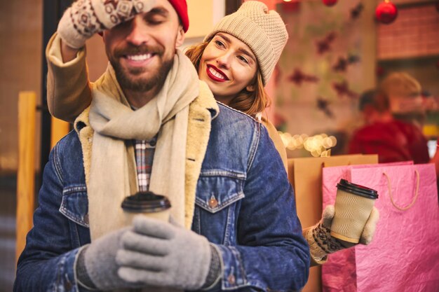 A split image showing a woman receiving a free birthday gift at a Sephora store and a man enjoying a free birthday coffee at Starbucks, highlighting the diverse range of birthday freebies available.