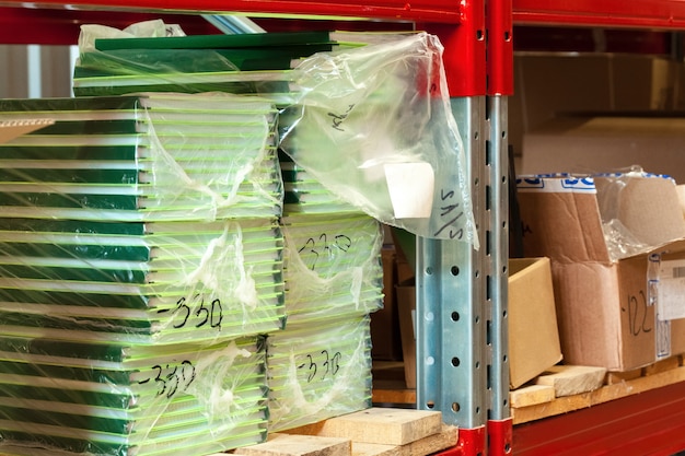 An organized coupon binder with clear plastic sleeves holding various clipped coupons, categorized by product type and expiration date. The binder is neatly labeled and accompanied by a shopping list.