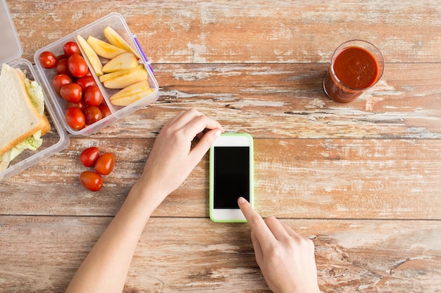 A close-up shot of a person's hands using a smartphone to redeem a free food reward on an app. The app interface is clean and user-friendly, with a clear display of the reward being redeemed. The background is blurred to focus on the smartphone and the act of redeeming the free food.