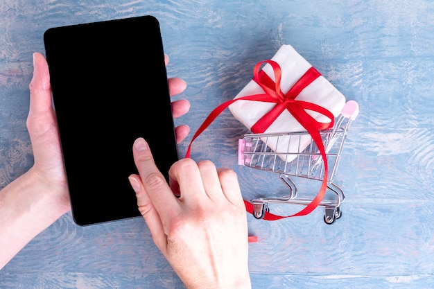 A hand holding a smartphone with a cash-back shopping app interface showing various deals and offers. The background features a blurred image of a grocery store aisle, emphasizing the cash-back aspect of the app.