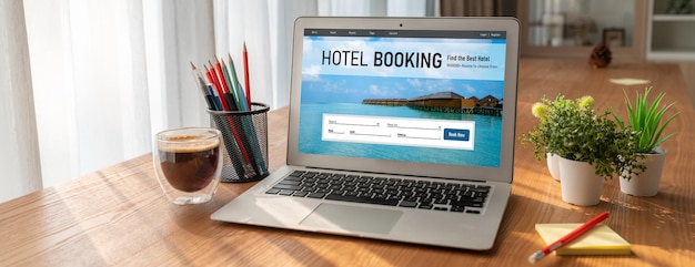 A laptop displaying a hotel booking website with highlighted discount prices and promotional offers, set against a background with travel-related items such as a passport, a map, and a miniature airplane. The focus is on the laptop screen, showcasing the available deals.