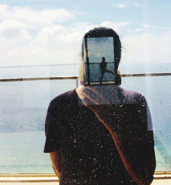 A split-screen image showing a traveler using a smartphone app on one side and a family enjoying a hotel swimming pool on the other, symbolizing the combination of technology and leisure in modern travel.