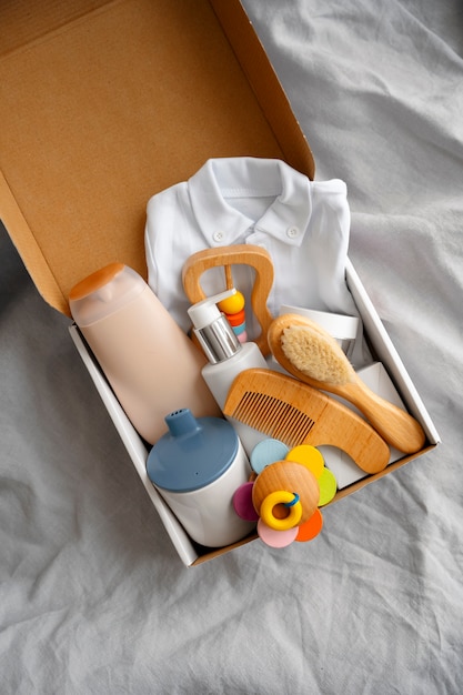 A close-up shot of a welcome box from a baby registry, showcasing various samples and small baby items like bottles, pacifiers, and lotions.