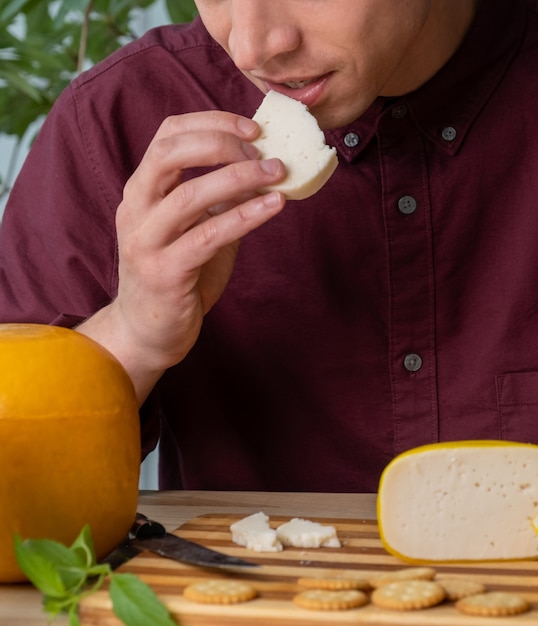 A close-up shot of a friendly demonstrator offering a sample of artisanal cheese to a shopper in a grocery store. Focus on the interaction between the two, emphasizing the personal connection and the appealing presentation of the cheese.