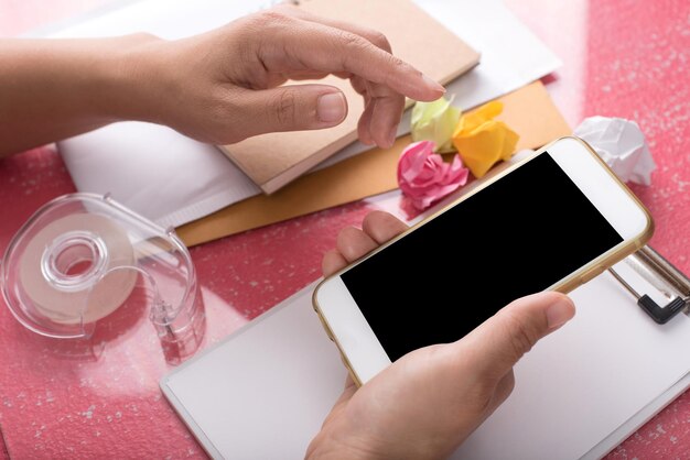 A person's hands holding a smartphone, displaying an Instagram post from a perfume brand announcing a giveaway of free perfume samples.