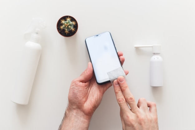 A hand holding a smartphone displaying a social media page of a cleaning product brand, with a highlighted post advertising a free cleaning kit giveaway.