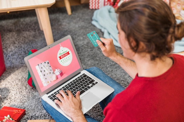 A close-up of a laptop screen displaying a website listing various free subscription box offers. The website features colorful banners and clear call-to-action buttons. The surrounding environment is a bright home office setting.