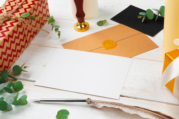 Close-up shot of a handwritten letter requesting free stickers, along with a self-addressed stamped envelope, sitting on a wooden desk alongside various colorful stickers already collected.