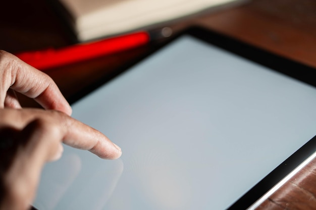 A close-up of terms and conditions displayed on a tablet screen, with a finger pointing at a specific clause related to geographical restrictions. Symbols of magnifying glass and document checklist are subtly visible.