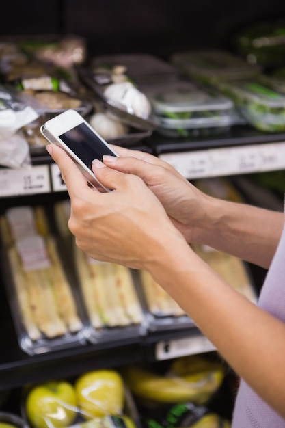 A close-up of an EBT card being used at a grocery store checkout. The focus is on the card and the scanner, with blurred background to maintain privacy. The image conveys the practicality of SNAP benefits in daily life.