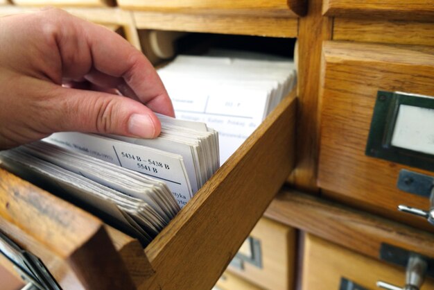 A person organizing various documents, including bills, pay stubs, and official letters, on a desk, symbolizing the preparation needed for the ERAP application process.