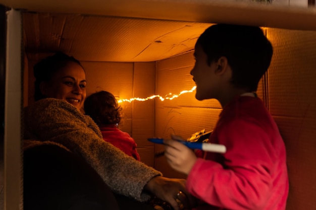 A family huddled in a dimly lit home, suggesting energy poverty and the struggle to afford heating and cooling.