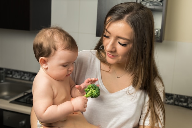 A happy mother holding her healthy baby, both benefiting from the WIC program.