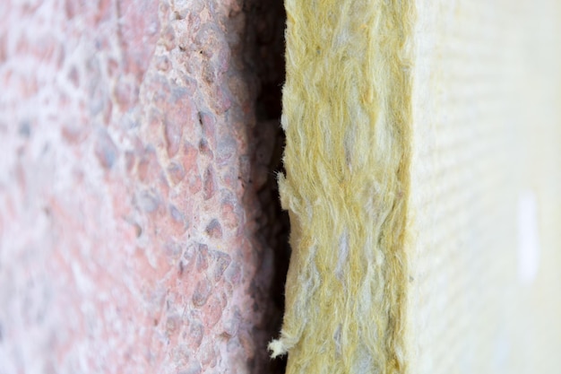 A close-up of a well-insulated attic, showing thick layers of insulation material, highlighting the benefits of energy-efficient home improvements.