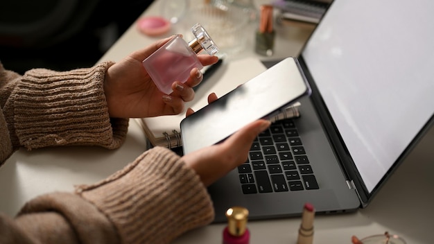 A person browsing a website on a laptop filled with beauty product images, with the search bar highlighting keywords like 