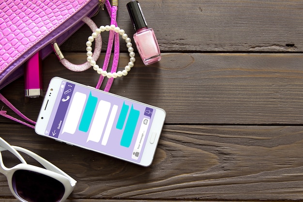 A close-up of a smartphone screen displaying an email newsletter from a beauty brand announcing a free full-size product with a purchase promo code, alongside push notifications from beauty apps.