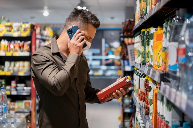 A Target employee marking down prices on a shelf full of clearance items. The employee is holding a price gun and applying new clearance tags to the products.