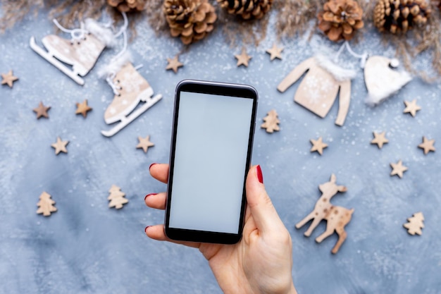 A hand holding a smartphone displaying a social media post from a baby product brand announcing a giveaway contest.